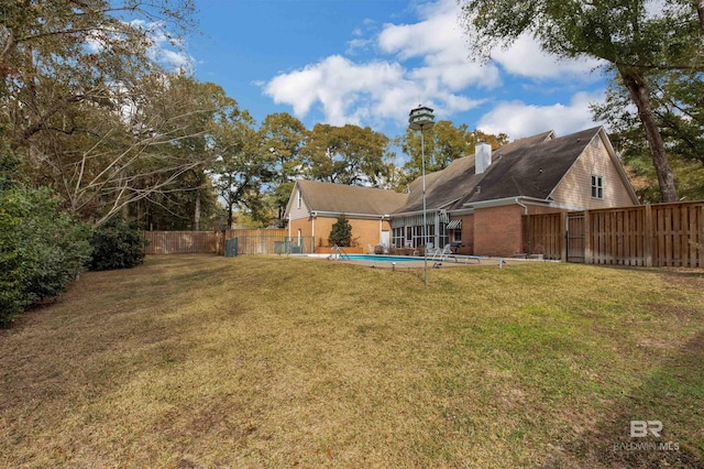 view of yard with a fenced in pool