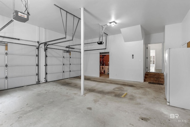 garage featuring a garage door opener and white refrigerator