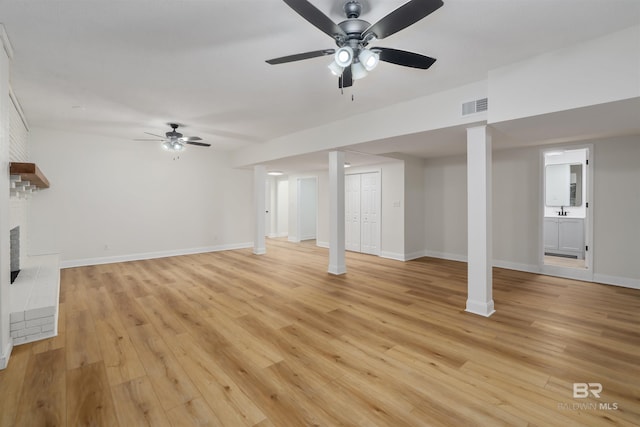 basement featuring ceiling fan and light wood-type flooring