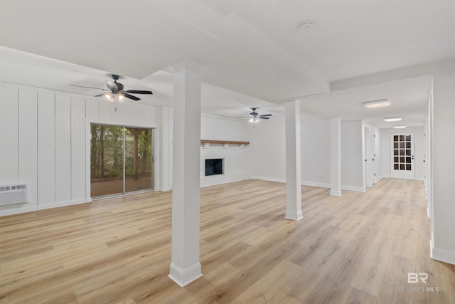 unfurnished living room featuring a fireplace, ceiling fan, and light hardwood / wood-style floors