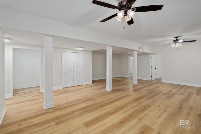 basement featuring light hardwood / wood-style floors and ceiling fan