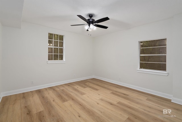 empty room with light hardwood / wood-style flooring and ceiling fan