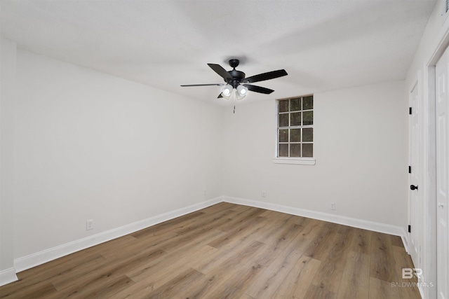 empty room featuring light hardwood / wood-style flooring and ceiling fan