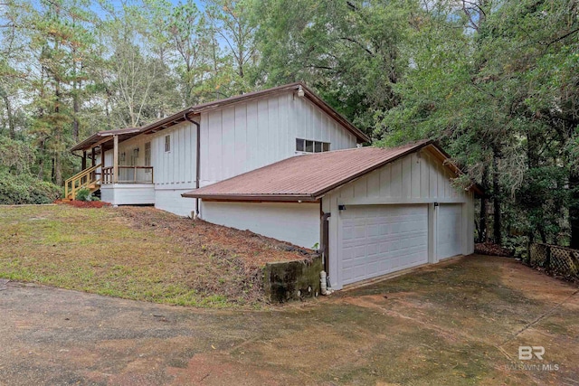 view of home's exterior featuring a porch and a garage