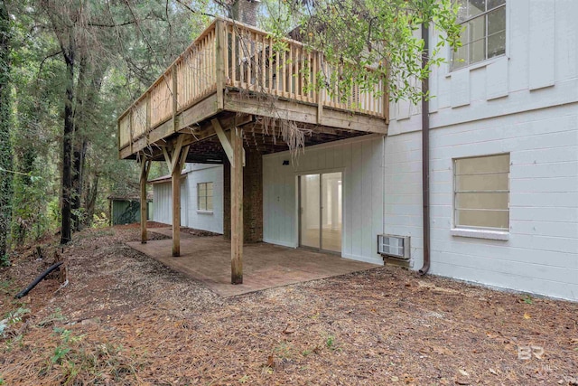 back of house featuring heating unit and a wooden deck