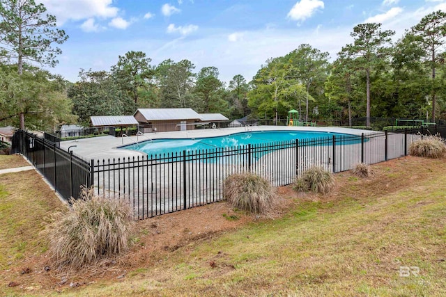 view of pool featuring a yard and a patio area