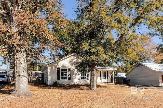 view of front of property with cooling unit and a porch