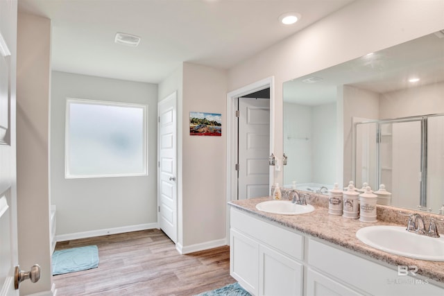 bathroom featuring separate shower and tub, hardwood / wood-style flooring, and vanity