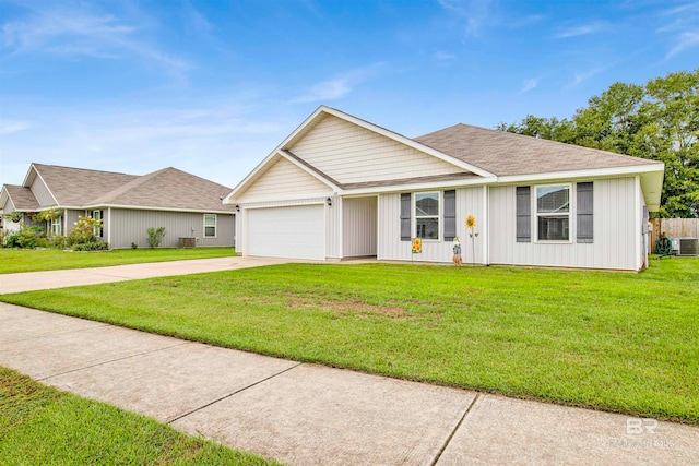 ranch-style house featuring a garage and a front lawn