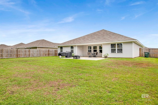 back of property featuring a lawn and a patio