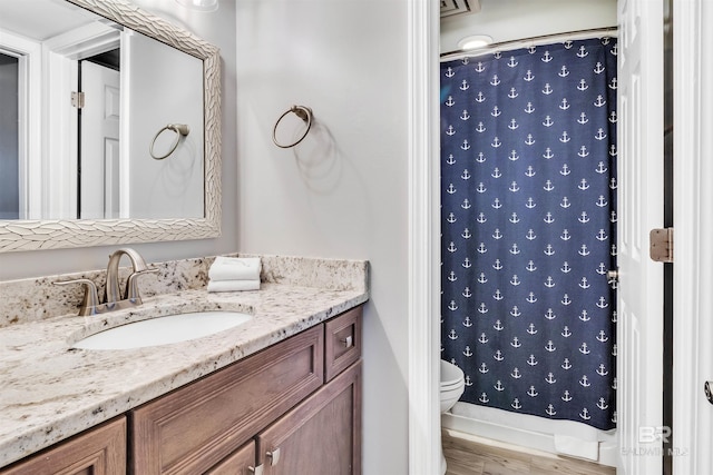 bathroom featuring toilet, a shower with curtain, vanity, and wood-type flooring