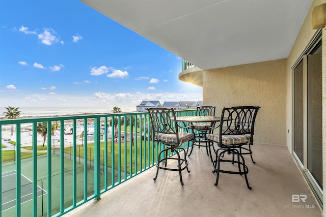 balcony with a view of the beach and a water view