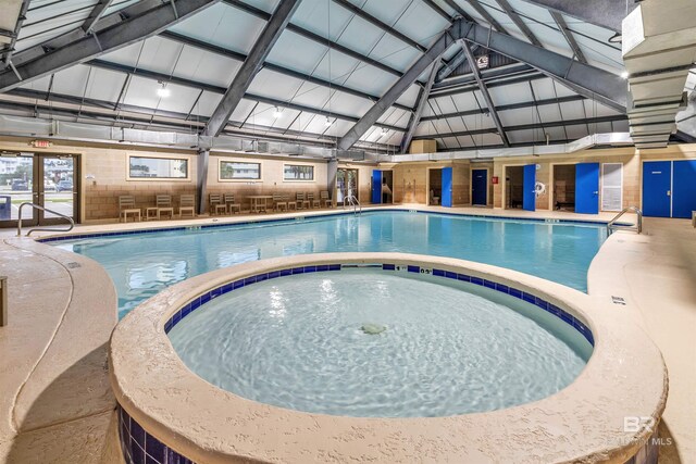 view of pool with an indoor hot tub