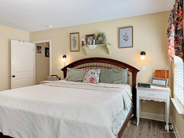 bedroom with hardwood / wood-style flooring