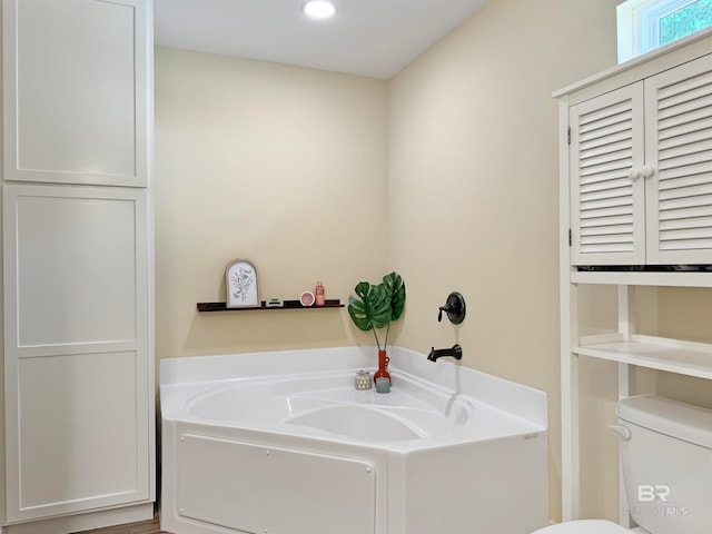 bathroom with a bathtub and toilet