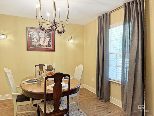 dining room featuring light hardwood / wood-style flooring and an inviting chandelier