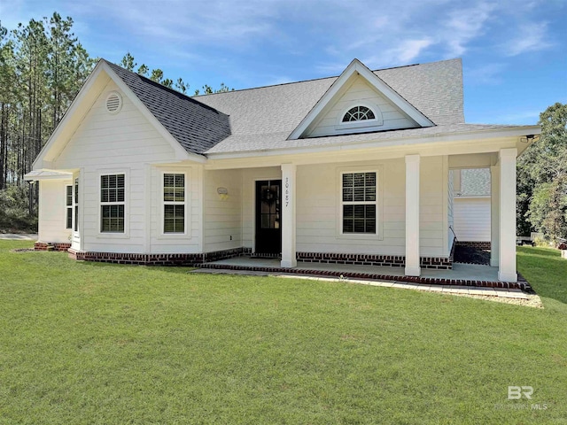 view of front of house with a porch and a front lawn