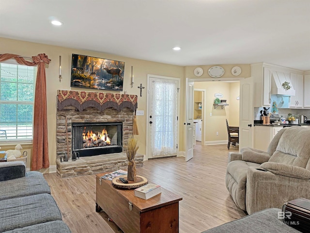 living room featuring light hardwood / wood-style floors and a fireplace