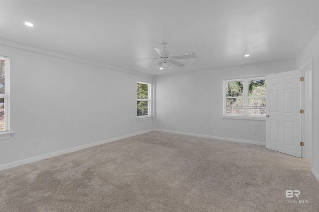 unfurnished room with baseboards, recessed lighting, and light colored carpet