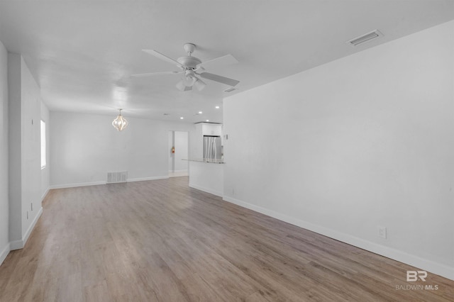 unfurnished living room featuring a ceiling fan, visible vents, and light wood-style floors