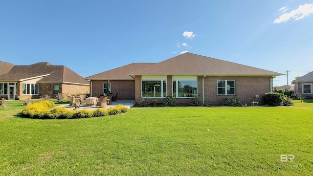 22355 County Road 12, Foley, AL 36535 - rear view of house with a patio, a yard, and brick siding