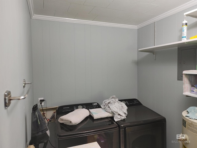 laundry area featuring separate washer and dryer, crown molding, and wood walls