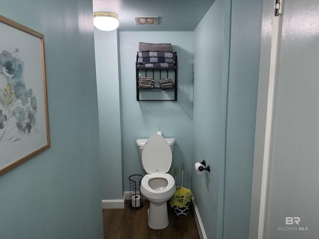 bathroom featuring hardwood / wood-style floors and toilet