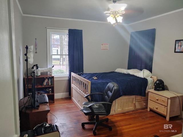 bedroom featuring dark hardwood / wood-style floors, ceiling fan, and ornamental molding