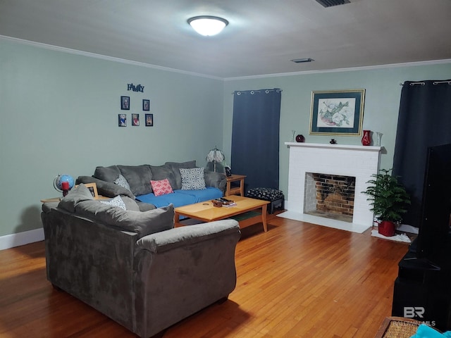 living room featuring wood-type flooring and crown molding