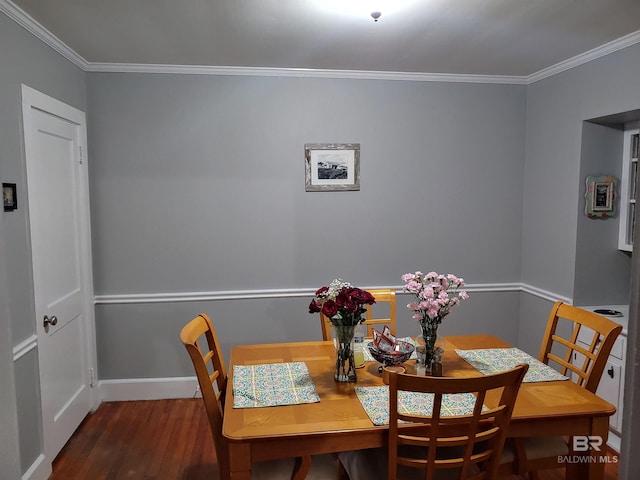 dining area with dark hardwood / wood-style floors and ornamental molding