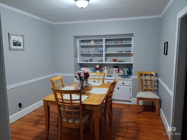 dining room with wood-type flooring, built in features, and ornamental molding