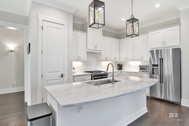 kitchen with pendant lighting, sink, an island with sink, white cabinetry, and stainless steel appliances