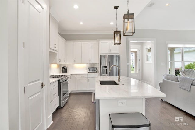 kitchen with a center island with sink, visible vents, white cabinets, appliances with stainless steel finishes, and pendant lighting