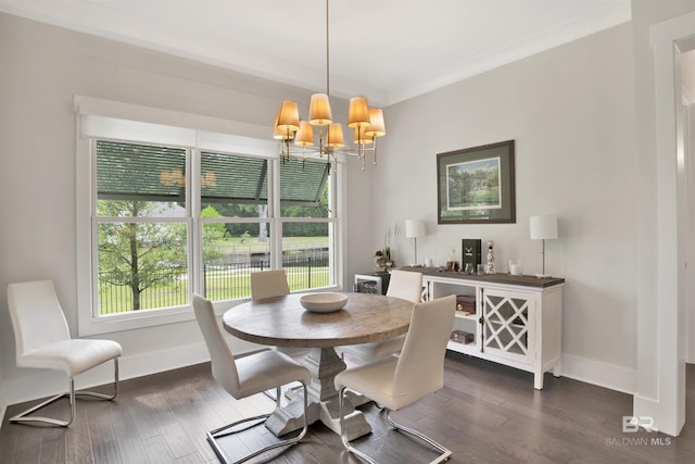 dining space with a chandelier, ornamental molding, and dark wood-type flooring