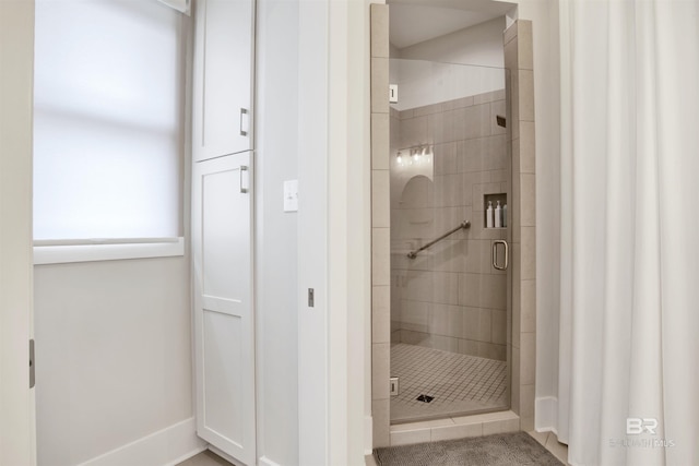 bathroom with a shower with shower door