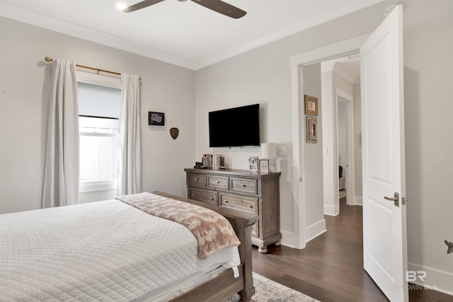 bedroom with dark wood-style floors, crown molding, baseboards, and a ceiling fan