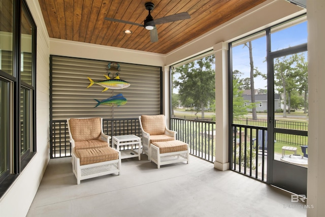 sunroom featuring wooden ceiling, plenty of natural light, and ceiling fan