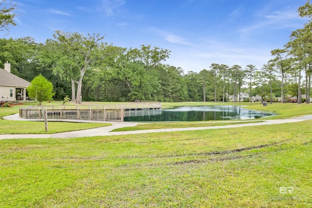 view of community featuring a water view and a yard