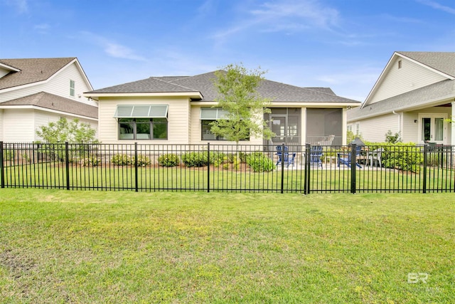 view of front facade featuring a front yard, a sunroom, and fence