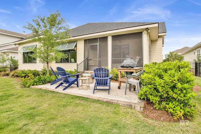 back of house with a lawn, a sunroom, and a patio