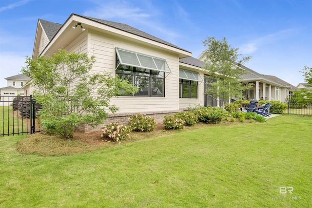 view of property exterior featuring fence and a lawn