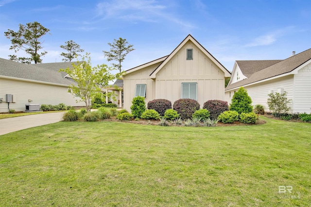 view of front of property with driveway, a front lawn, and board and batten siding