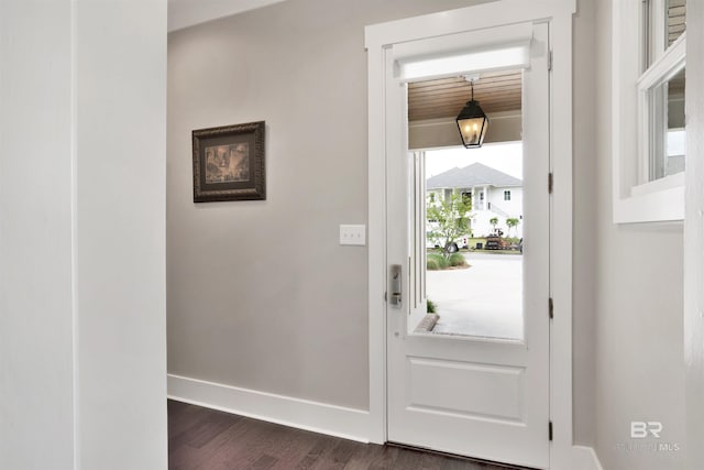 entrance foyer featuring dark wood-style flooring and baseboards