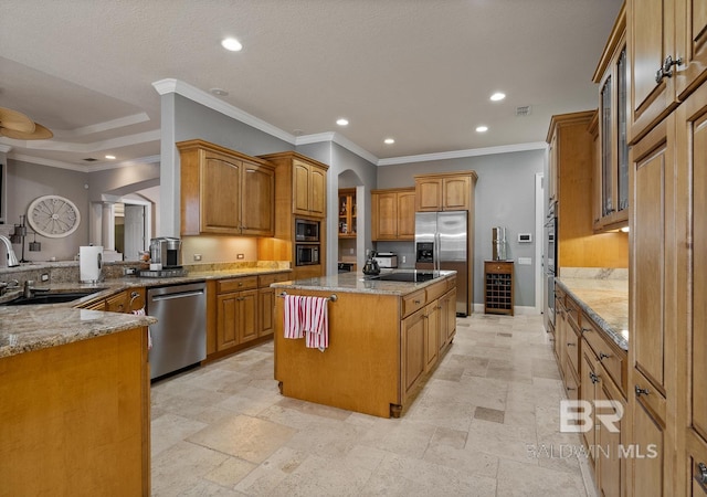 kitchen featuring sink, a center island, ornamental molding, and appliances with stainless steel finishes