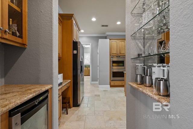 kitchen featuring light stone countertops, stainless steel appliances, and ornamental molding