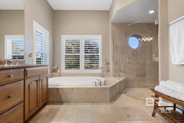 bathroom with separate shower and tub, vanity, and a healthy amount of sunlight