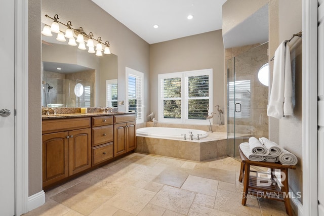 bathroom featuring vanity and shower with separate bathtub