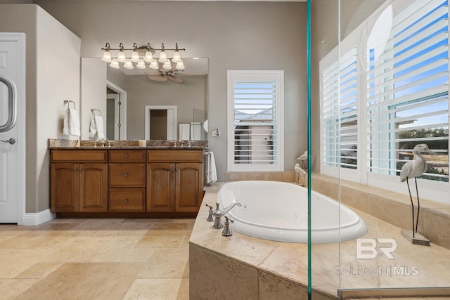 bathroom featuring vanity and a relaxing tiled tub