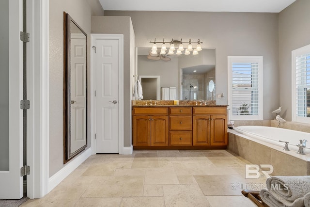 bathroom with vanity and shower with separate bathtub