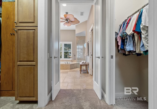 hallway featuring light colored carpet